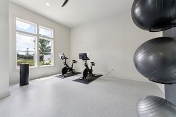 A room with exercise equipment and a large exercise ball.